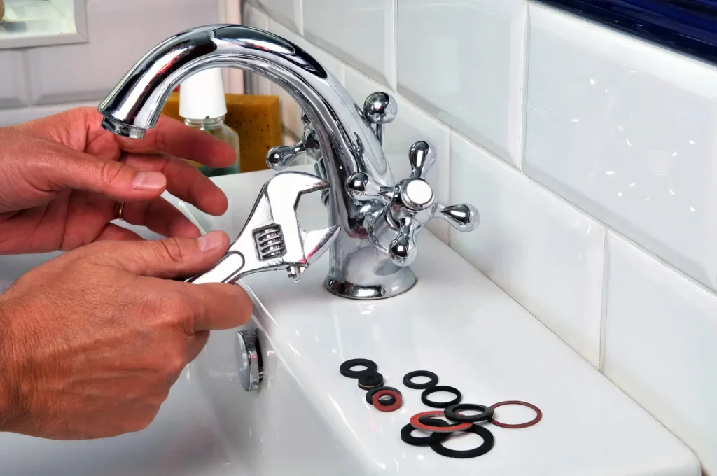 Plumber performing maintenance on a bathroom faucet in Marietta