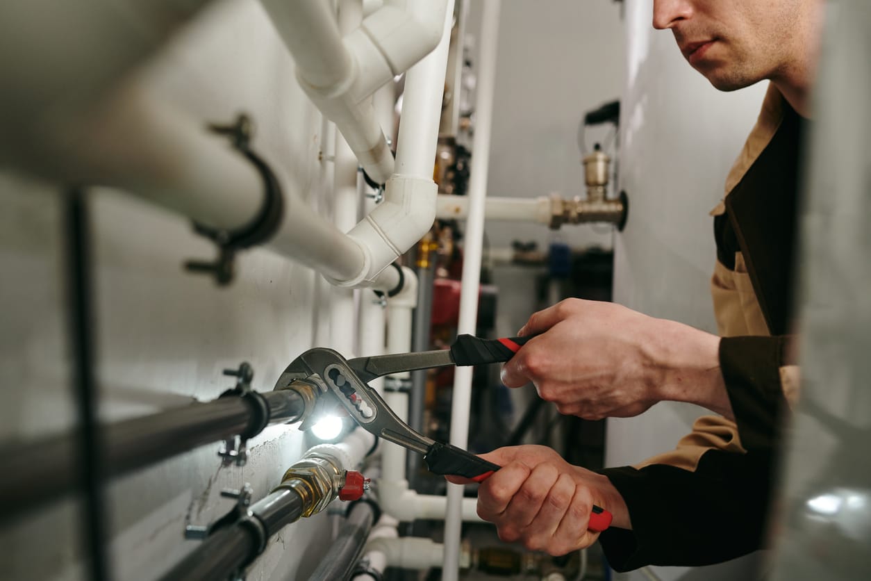 Plumbers maintaining commercial plumbing pipes in Marietta
