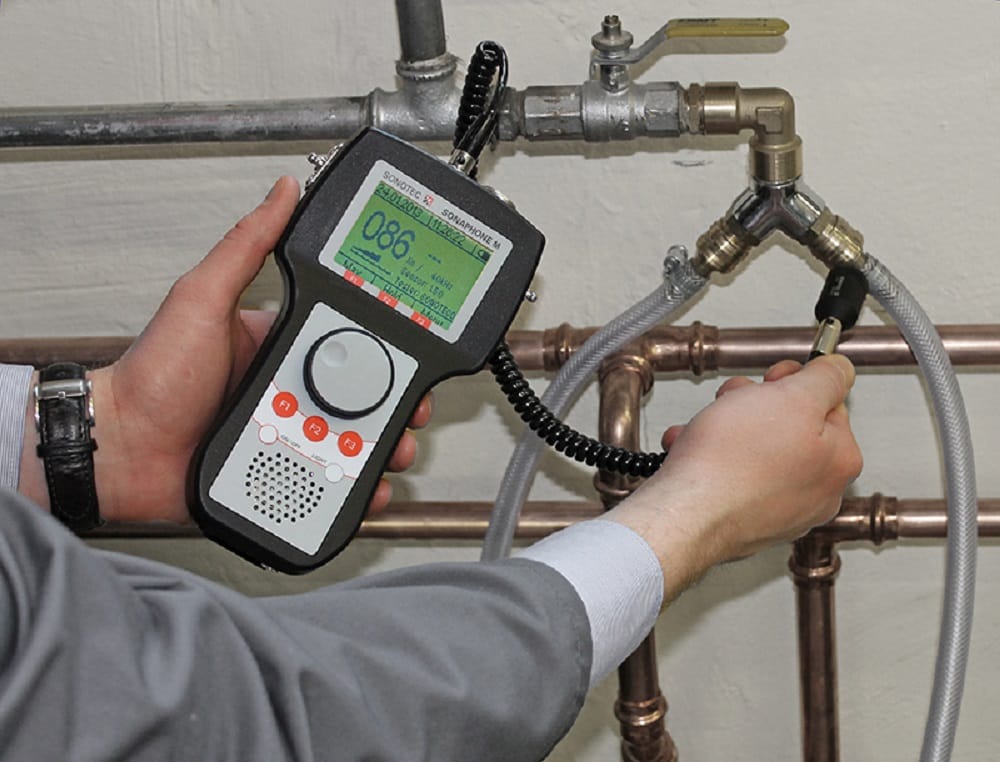 Plumber testing pipes with electronic leak detection equipment in Marietta