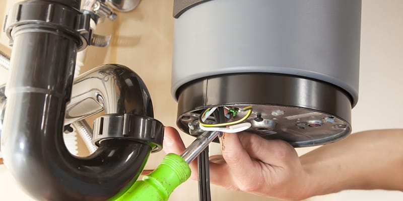 Technician repairing the heating element of a water heater in Marietta