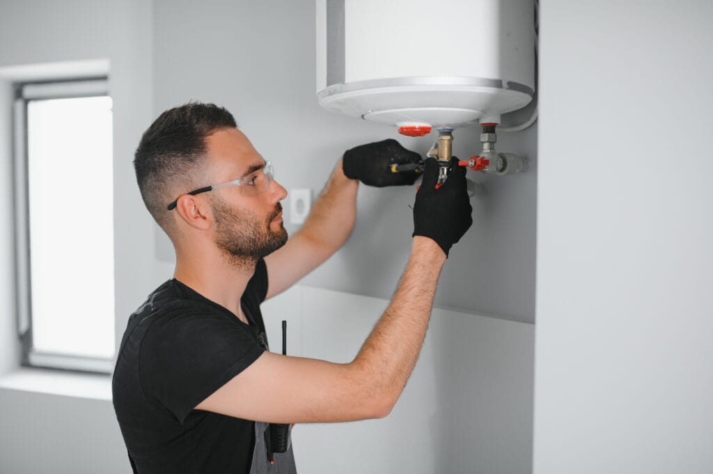 Technician performing water heater maintenance in Marietta