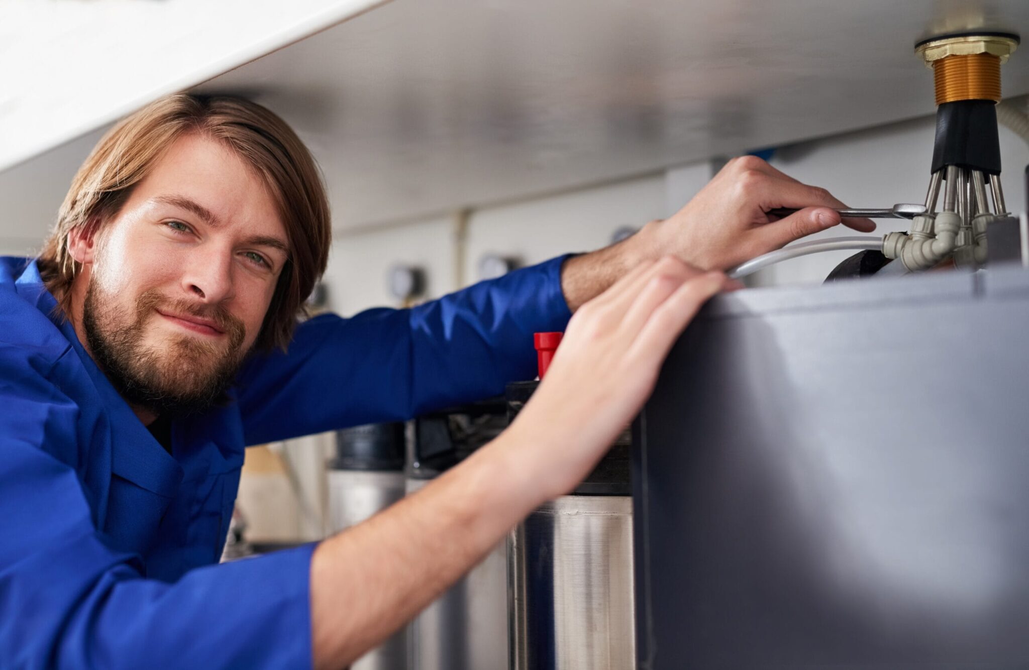 Technician servicing a residential water heater tank in Marietta