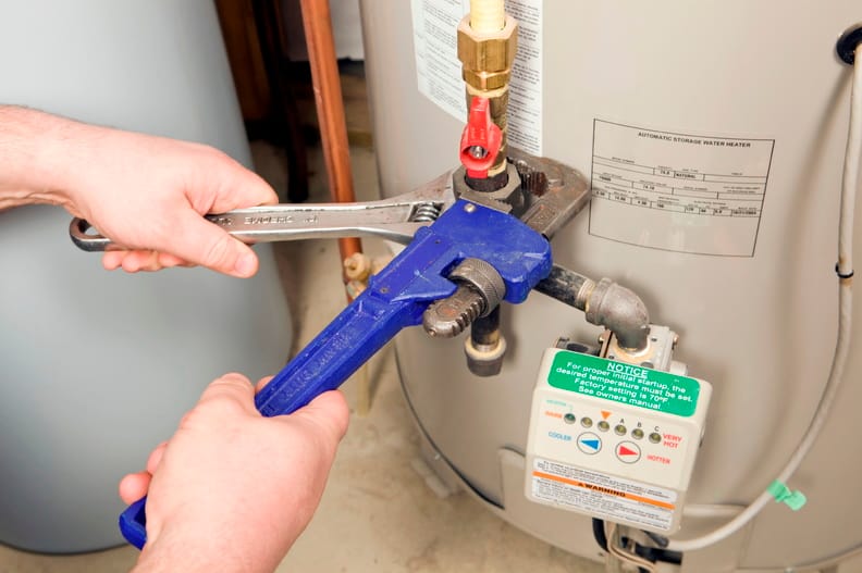 Plumber repairing a water heater valve in Marietta